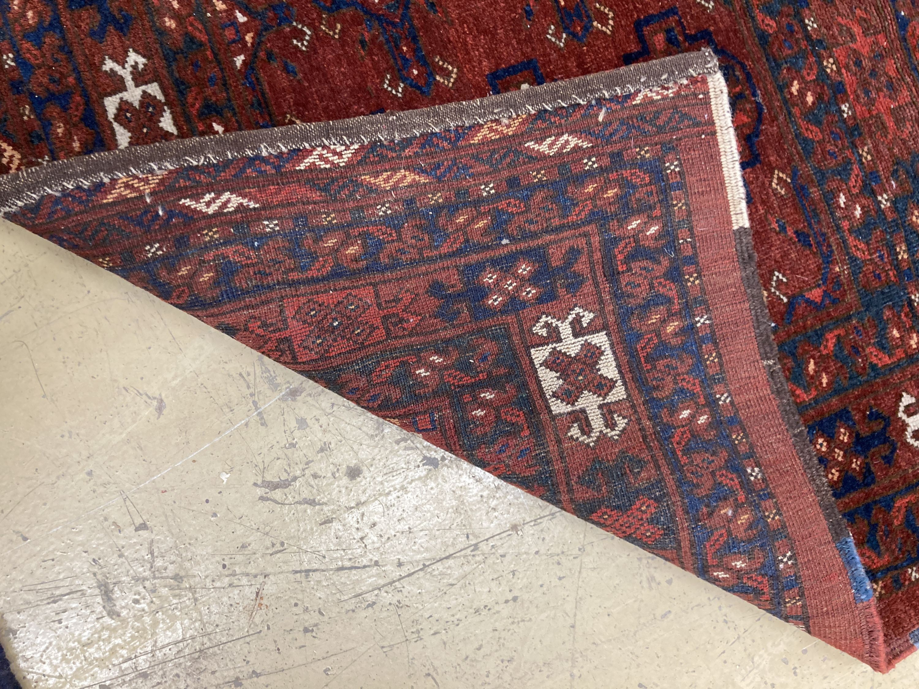 An antique Tekke burgundy ground rug, 150 x 92cm